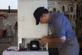 Appliance service technician in his workshop repairing a faulty refrigerator. Technician at work Royalty Free Stock Photo