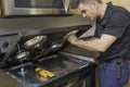 Appliance technician checking a stovetop range