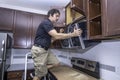 Appliance technician installing a microwave