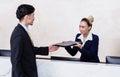 Applicant giving his documents to receptionist