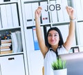 Happy girl holding a poster with the inscription work. The applicant was interviewed and got a job in the office. Royalty Free Stock Photo