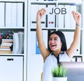 Happy girl holding a poster with the inscription work. The applicant was interviewed and got a job in the office. Royalty Free Stock Photo