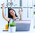 Happy girl holding a poster with the inscription work. The applicant was interviewed and got a job in the office. Royalty Free Stock Photo