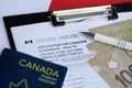 Application for Canadian citizenship for adults on table with pen, passport and dollar bills Royalty Free Stock Photo