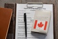 Application form, pen and a Canadian passport