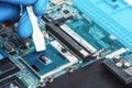 Application of thermal paste on the laptop processor chip for high-quality cooling Royalty Free Stock Photo