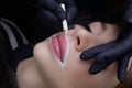 application of a white contour with a pencil on the lips before the procedure of permanent lip makeup