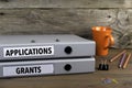 Applications and Grants - two folders on wooden office desk Royalty Free Stock Photo