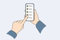 Applications for task management on phone in hands of person using checklist with ticks