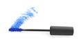 Applicator brush and blue mascara stroke on white background, top view