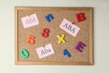 Applied behavior analysis concept. Paper notes with abbreviation ABA, colorful letters and numbers on corkboard Royalty Free Stock Photo