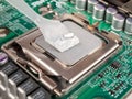 Applied thermal paste on the thermal distribution cover, heat removal from the chip processor, motherboard Royalty Free Stock Photo