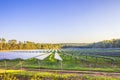 Field of rows of solar panels with green grass