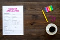 Apply college. Empty college application form near coffee cup and stationery on dark wooden background top view copy