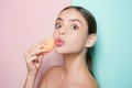 Apply concealer and cosmetic highlighter. Girl hold cosmetic applicator. Woman spreading cream on her face. Skin cream Royalty Free Stock Photo