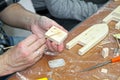 Apply glue to the workpiece. Master class on manufacturing of wooden ship Royalty Free Stock Photo