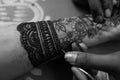 Applying Beautiful henna art on hands. Bridal design. Wedding Mehendi. Royalty Free Stock Photo