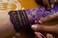 Applying Beautiful henna art on hands. Bridal design. Wedding Mehendi. Royalty Free Stock Photo