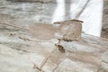 Applying a beige grout on the floor lined with tiles. Royalty Free Stock Photo