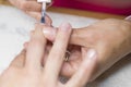 Applying coat of nail varnish in beauty salon Royalty Free Stock Photo