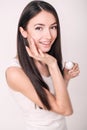 Applying cosmetic cream. A beautiful young woman applying face moisturizer. Scine care of the face and hands Royalty Free Stock Photo