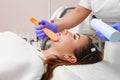 Applying cosmetic gel on the face patient. Royalty Free Stock Photo