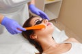 Applying cosmetic gel on the face patient. Royalty Free Stock Photo