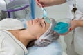 Applying cosmetic gel on the face patient. Royalty Free Stock Photo