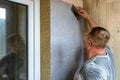 Applying decorative mosaic plaster on the wall. Royalty Free Stock Photo