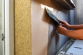Applying decorative mosaic plaster on the wall. Royalty Free Stock Photo