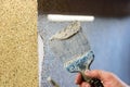 Applying decorative mosaic plaster on the wall. Royalty Free Stock Photo