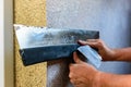 Applying decorative mosaic plaster on the wall. Royalty Free Stock Photo
