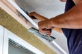 Applying decorative mosaic plaster on the wall. Royalty Free Stock Photo