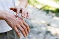 Applying an emollient to dry flaky skin as in the treatment of psoriasis, eczema and other dry skin conditions. White Royalty Free Stock Photo