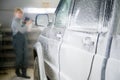 Applying a foam solution to a car at a shallow depth of field