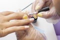 Applying gel polish on the nails. shellac. manicurist makes manicure in salon. natural color varnish. nude hue