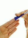 Applying gel with a tube to a finger Topical treatment concept