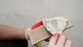 Working grouting of tiles, applying grout to the seam of tiles for home renovation in the kitchen. Applying grout to