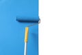 Applying light blue paint with roller brush on white wall Royalty Free Stock Photo