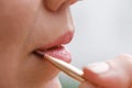 Applying lip makeup, close-up of woman face with