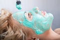 Applying mud face pack on woman face Royalty Free Stock Photo