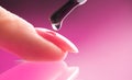 Applying Nail polish, pink shellac UV gel, varnish, manicure process concept in beauty salon