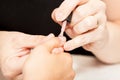 Applying nail polish on a woman`s hands