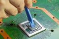 Applying a new thermal grease paste to the main CPU. Selective focus on the central processor unit Royalty Free Stock Photo