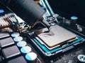 Applying new thermal paste to a CPU. Thermal paste used as an interface between heat sinks and CPU. Royalty Free Stock Photo