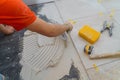 Applying new tiles on bathroom floor installation for house building Royalty Free Stock Photo