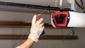 Applying oil to a chain of a garage door opener Royalty Free Stock Photo