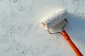Applying a paint roller on textured drywall surface for an even and smooth finish Royalty Free Stock Photo