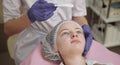 Applying Peeling on the face. A young girl in a cosmetology office is undergoing facial skin rejuvenation procedures