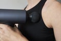 Applying therapeutic percussive massager gun at home Royalty Free Stock Photo